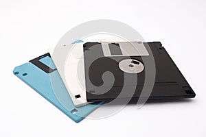 Retro vintage floppy disk diskettes on white, old time computer storage equipment hardware