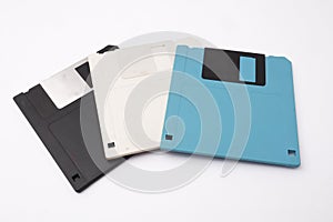 Retro vintage floppy disk diskettes on white, old time computer storage equipment hardware