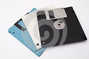 Retro vintage floppy disk diskettes on white, old time computer storage equipment hardware