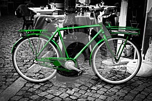 Retro vintage green bike on black and white street background