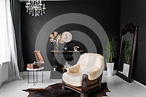 Retro vintage interior. Retro living room interior in dark black colors. Retro leather chair and fireplace