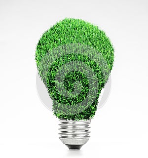 Retro vintage light bulb with green grass on top on white background