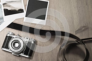 Retro vintage photography concept of three instant photo frames cards on wooden background with old camera and film strip