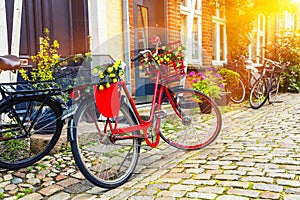 Retro vintage red bicycle on cobblestone street in the old town