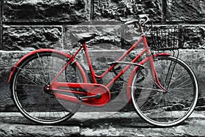 Retro vintage red bike on black and white wall.