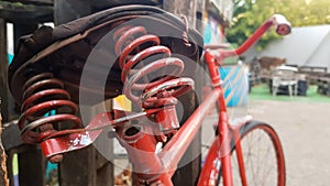 Retro vintage red bike close up. An old charming concept of a classic abandoned bike