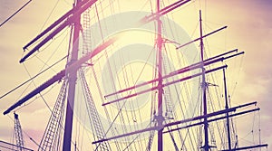 Retro vintage toned sailing masts at sunset.