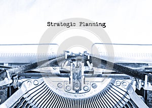 Retro vintage typewriter with a sheet of paper with printed text Strategic Planning.