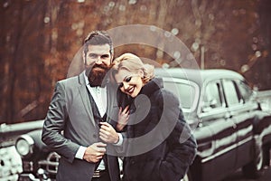 A retro wedding car with just married couple in love.