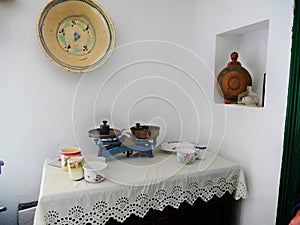 Retro weighing scale on a white table cloth, various porcelain household items