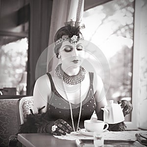 Retro Woman 1920 - 1930 Sitting in a Restaurant