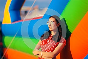 Retro Woman at Garden Party Near Bouncy House