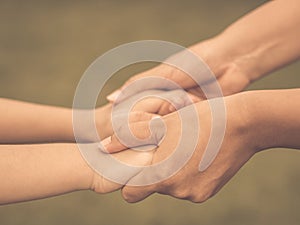 Retro woman holds the hand of a lovely child.