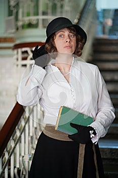 retro, woman holds her hand to black hat