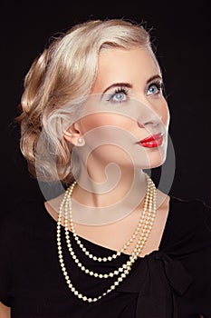 Retro woman with jewelry over black background