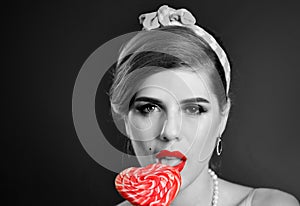 Retro woman licking lollipop lolly. Black and white photo