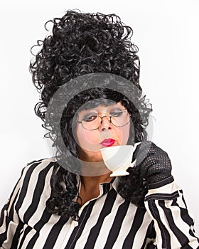 Retro Woman Portrait with cup of coffee. Style woman wearing high black wig and lace gloves