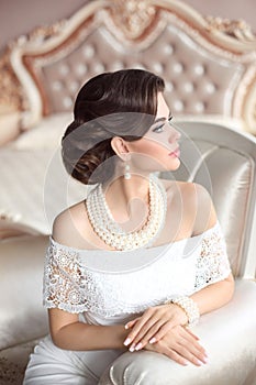 Retro woman portrait. Elegant brunette lady with fashion pearls