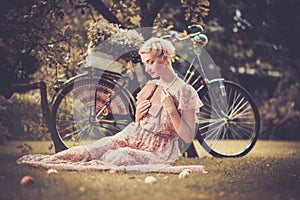 Retro woman sitting on a meadow