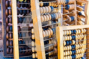Retro wooden abacus lie in a heap on the ground
