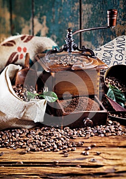 Retro wooden coffee mill with roasted beans