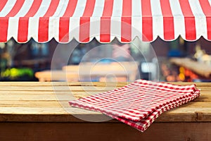 Retro wooden counter with tablecloth and awing for product montage display