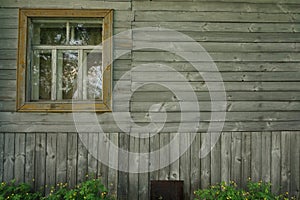 Retro wooden wall with window and flowers