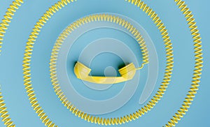 telephone handset with coiled cord towards the center of the image
