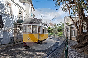 Retro yellow tram on street in Lisbon, Portugal