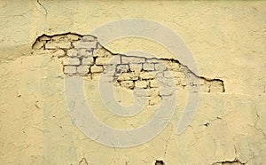 Retro ytellow brick wall with crack as background closeup