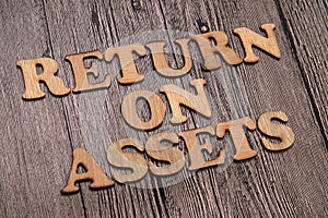 Return on Assets ROA, text words typography written on wooden background, life and business motivational inspirational