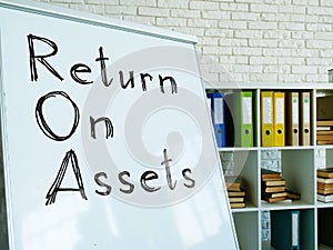 Return on Assets ROA written on the whiteboard. photo