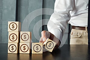 Return on Capital Employed ROCE is shown on photo using wooden cubes and signs of dollar