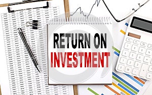 LEAD BY EXAMPLE text on sticky on red notebook on chart background