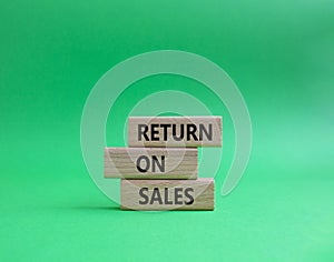 Return on Sales symbol. Concept word Return on Sales on wooden blocks. Beautiful green background. Business and Return on Sales