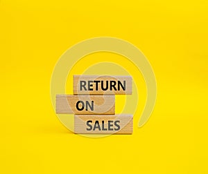 Return on Sales symbol. Concept word Return on Sales on wooden blocks. Beautiful yellow background. Business and Return on Sales