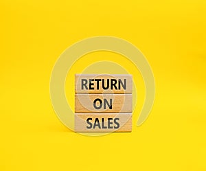 Return on Sales symbol. Concept word Return on Sales on wooden blocks. Beautiful yellow background. Business and Return on Sales