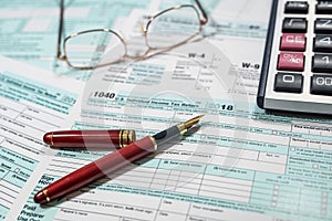 return U.S tax forms 1040 with pen calculator and glasses, business financial concept