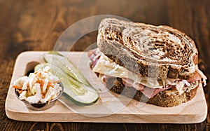 Reuben sandwich with kosher dill pickle and coleslaw