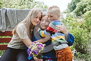 Reunited, family, togetherness, relationships, meeting, embracing. Grandson and granddaughter visit grandmother after