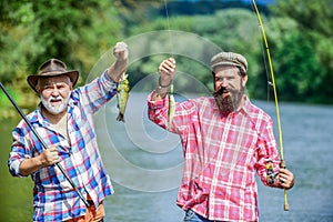 Reunited and it feel so good. father and son fishing. summer weekend. mature men fisher. hobby and sport activity. Trout