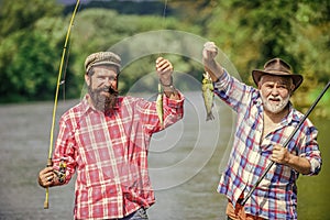 Reunited and it feel so good. father and son fishing. summer weekend. mature men fisher. hobby and sport activity. Trout