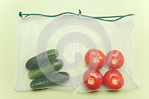 Reusable bags with, fresh vegetables tomatoes, cucumbers, bell peppers over white background