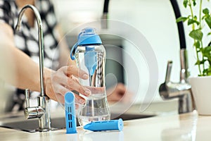 Reusable bottle of water with spare carbon filters