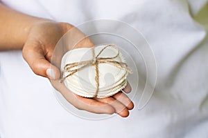 Reusable cotton pads in the woman`s hand