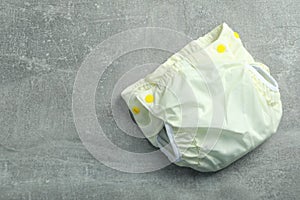 Reusable diapers on gray textured background, close up