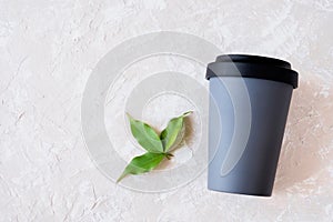 Reusable eco friendly bamboo cup on neutral background with copy space.