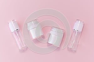 Reusable glass white bottles for oil, cream, lotion or serum on a pink background. Zero waste, eco-friendly