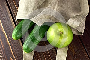 Reusable linen shopping bag filled with green fruits and vegetables