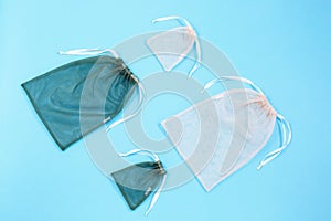 A reusable mesh bags for grocery shopping filled on blue background